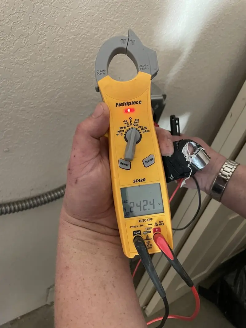 Voltage testing with clamp meter during Recessed Lighting Installation in Brady